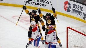 Boston Bruins players Mark Kastelic and Trent Frederic celebrate a goal by teammate Charlie Coyle as Montreal Canadiens defenceman Mike Matheson and goaltender Cayden Primeau look on during the first period of an NHL hockey game, Sunday, Dec. 1, 2024, in Boston. (Mary Schwalm/AP)