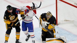 Boston Bruins goaltender Jeremy Swayman (1) makes a save as Montreal Canadiens' Alex Newhook, center, and Bruins' Nikita Zadorov (91) look for a deflection during the second period of an NHL hockey game, Sunday, Dec. 1, 2024, in Boston. (Mary Schwalm/AP)