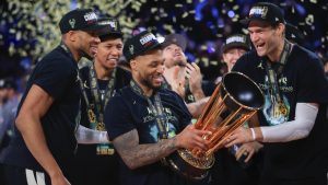 Milwaukee Bucks forward Giannis Antetokounmpo (34), Milwaukee Bucks guard Damian Lillard (0), and Milwaukee Bucks center Brook Lopez (11) celebrate after their team's victory in the championship game of the NBA Cup basketball tournament against the Oklahoma City Thunder Tuesday, Dec. 17, 2024, in Las Vegas. (Ian Maule/AP)