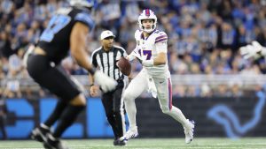 Buffalo Bills quarterback Josh Allen (17) rolls out to pass against the Detroit Lions during the first half of an NFL football game, Sunday, Dec. 15, 2024, in Detroit. (Rey Del Rio/AP)