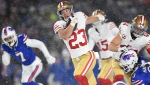 San Francisco 49ers running back Christian McCaffrey (23) runs against Buffalo Bills safety Taylor Rapp, bottom, during the first half of an NFL football game in Orchard Park, N.Y. (Adrian Kraus/AP)