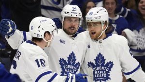 Toronto Maple Leafs center Auston Matthews (34) celebrates his goal against the Tampa Bay Lightning with right wing William Nylander (88) and right wing Mitchell Marner (16) during the third period in Game 4 of an NHL hockey Stanley Cup first-round playoff series Monday, April 24, 2023, in Tampa, Fla. (AP Photo/Chris O'Meara)