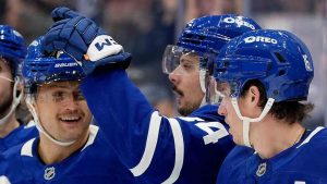 Toronto Maple Leafs centre Auston Matthews (34) celebrates his goal with teammates William Nylander (88) and Mitch Marner (16) during second period NHL hockey action against the Tampa Bay Lightning, in Toronto, Monday, Oct. 21, 2024. (Frank Gunn/CP)