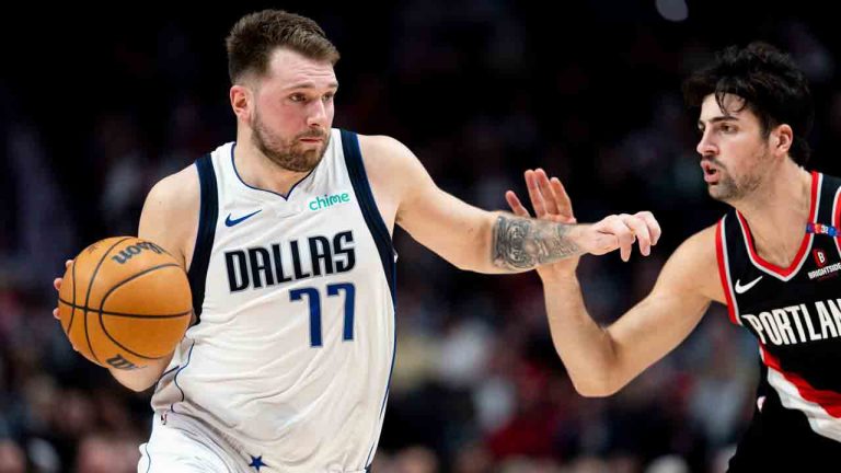 Dallas Mavericks guard Luka Doncic, left, dribbles the ball against Portland Trail Blazers forward Deni Avdija, right, during the first half of an NBA basketball game Sunday, Dec. 1, 2024, in Portland, Ore. (Howard Lao/AP)