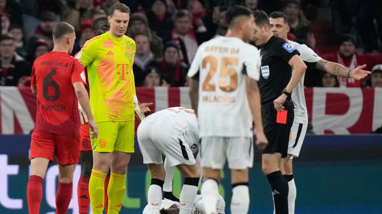 Bayern's goalkeeper Manuel Neuer, receives a red card by the referee during a German Cup round of 16 soccer match between Bayern Munich and Bayer Leverkusen at the Allianz Arena in Munich, Germany, Monday. Dec.3, 2024. (AP Photo/Matthias Schrader)