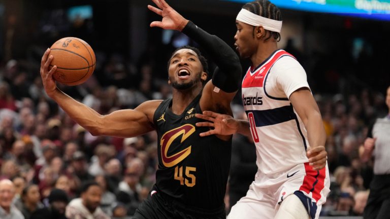 Cleveland Cavaliers guard Donovan Mitchell (45) drives against Washington Wizards' Bilal Coulibaly, right, in the half of an NBA Cup basketball game, Tuesday, Dec. 3, 2024, in Cleveland. (AP Photo/Sue Ogrocki)