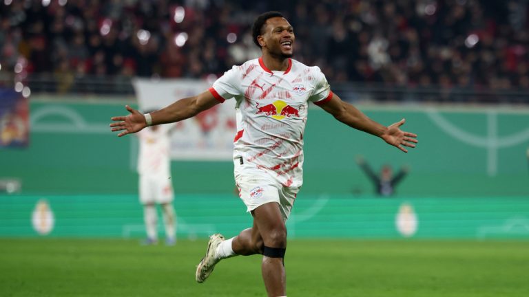 Leipzig's Lois Openda celebrates after scoring his side's third goal of the game during a German Cup match between RB Leipzig and Eintracht Frankfurt at the Red Bull Arena, in Leipzig, Germany, Wednesday, Dec. 4, 2024. (Jan Woitas/dpa via AP)