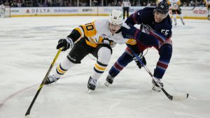 New York Rangers' Ryan Lindgren (55) fights for control of the puck with Pittsburgh Penguins' Drew O'Connor (10) during the third period of an NHL hockey game Friday, Dec. 6, 2024, in New York. (AP Photo/Frank Franklin II)