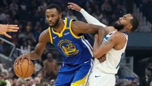 Golden State Warriors forward Andrew Wiggins (22) drives to the basket against Minnesota Timberwolves guard Mike Conley during the first half of an NBA basketball game in San Francisco, Friday, Dec. 6, 2024. (Jeff Chiu/AP)