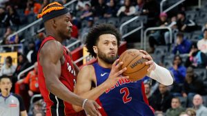 Detroit Pistons guard Cade Cunningham (2) drives to the basket against Miami Heat forward Jimmy Butler (22) during the second half of an NBA basketball game Monday, Dec. 16, 2024, in Detroit. (Duane Burleson/AP)