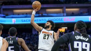 Denver Nuggets guard Jamal Murray (27) looks to shoot over Sacramento Kings guard De'Aaron Fox (5) during the first half of an NBA basketball game in Sacramento, Calif., Monday, Dec. 16, 2024. (Randall Benton/AP)