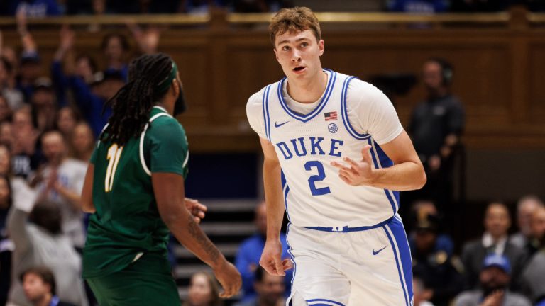 Duke's Cooper Flagg (2) reacts after hitting a three-point shot during the first half of an NCAA college basketball game against George Mason in Durham, N.C., Tuesday, Dec. 17, 2024. (AP Photo/Ben McKeown)