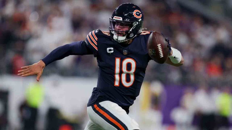 Chicago Bears quarterback Caleb Williams scrambles with the ball against the Minnesota Vikings during the first half of an NFL football game Monday, Dec. 16, 2024 in Minneapolis. Minnesota won 30-12. (Stacy Bengs/AP)