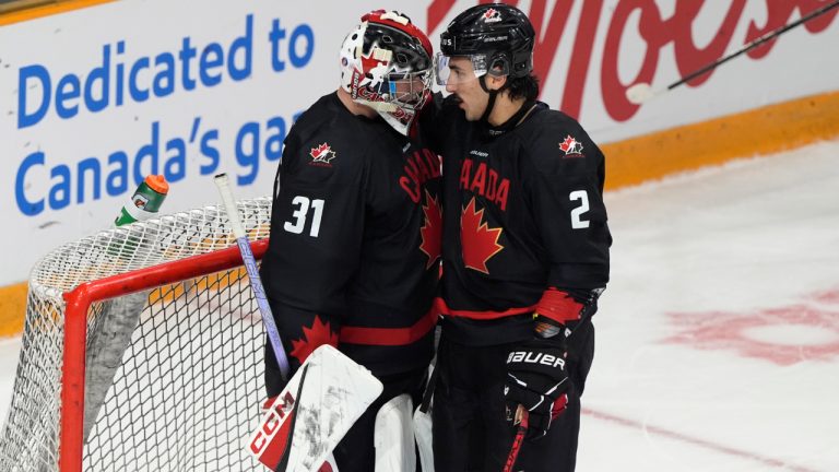 Canada defenceman Andrew Gibson congratulates goaltender Carson Bjarnason following their IIHF World Junior Hockey Championship pre-tournament win over Sweden, Saturday, Dec.21, 2024 in Ottawa. THE CANADIAN PRESS/Adrian Wyld