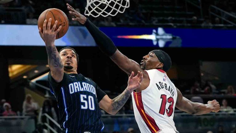 Orlando Magic guard Cole Anthony (50) makes a shot against Miami Heat center Bam Adebayo (13) during the second half of an NBA basketball game, Saturday, Dec. 21, 2024, in Orlando, Fla. (John Raoux/AP)