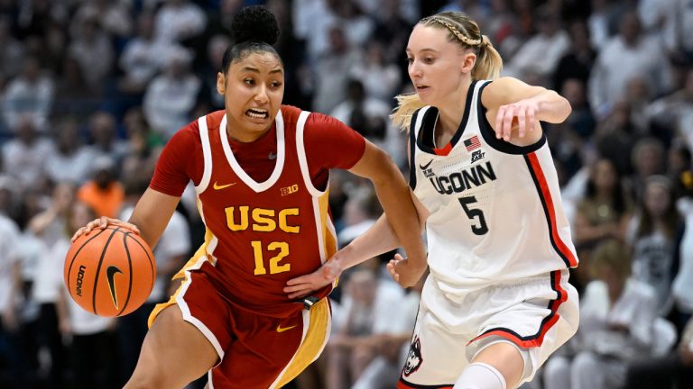 Southern California guard JuJu Watkins (12) is guarded by UConn guard Paige Bueckers (5) in the second half of an NCAA college basketball game, Saturday, Dec. 21, 2024, in Hartford, Conn. (AP Photo/Jessica Hill)