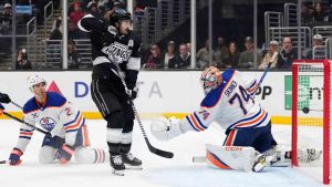 Edmonton Oilers goaltender Stuart Skinner, right, is scored on for the game-winning goal by Los Angeles Kings right wing Quinton Byfield, not seen, as defenceman Darnell Nurse, left, and centre Phillip Danault watch during the overtime period of an NHL hockey game, Saturday, Dec. 28, 2024, in Los Angeles. (Mark J. Terrill/AP)