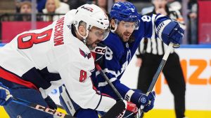 Washington Capitals' Alex Ovechkin battles with Toronto Maple Leafs' Chris Tanev during first-period NHL action in Toronto on Saturday, Dec. 28, 2024. (CP/Frank Gunn)