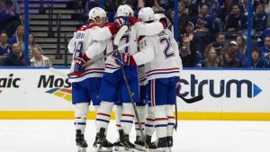 Montreal Canadiens center Christian Dvorak (28) celebrates with teammates after scoring a goal during the second period of an NHL hockey game against the Tampa Bay Lightning, Sunday, Dec. 29, 2024, in Tampa, Fla. (Mary Holt/AP)