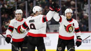 Ottawa Senators centre Ridly Greig, left, centre Josh Norris (9) and right wing Claude Giroux celebrate an empty-net goal during the third period of an NHL hockey game Minnesota Wild, Sunday, Dec. 29, 2024, in St. Paul, Minn. (Ellen Schmidt/AP)