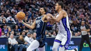 Dallas Mavericks guard Spencer Dinwiddie (26) drives to the basket past Sacramento Kings forward Keegan Murray, right, during the first half of an NBA basketball game, Monday, Dec. 30, 2024, in Sacramento, Calif. (Sara Nevis/AP)