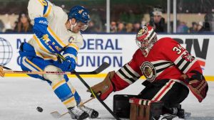 Chicago Blackhawks goaltender Petr Mrazek (34) makes a save against St. Louis Blues center Brayden Schenn, left, during the second period of the NHL Winter Classic outdoor hockey game at Wrigley Field, Tuesday, Dec. 31, 2024, in Chicago. (Erin Hooley/AP)