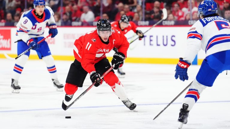 Canada's Brayden Yager (11) skates with the puck as USA's Drew Fortescue (5) defends during second period IIHF World Junior Hockey Championship tournament action in Ottawa on Tuesday, Dec. 31, 2024. (Sean Kilpatrick/CP)