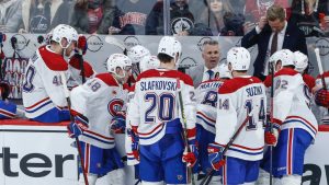 Montreal Canadiens head coach Martin St-Louis talks to his team during a last minute timeout in the third period NHL action against the Winnipeg Jets in Winnipeg, Saturday, Dec. 14, 2024. (John Woods/CP)