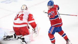 Montreal Canadiens' Cole Caufield (13) reacts to a goal by teammate Patrik Laine, not shown, against Detroit Red Wings goaltender Alex Lyon (34) during first period NHL hockey action in Montreal, Saturday, December 21, 2024. (Graham Hughes/CP)