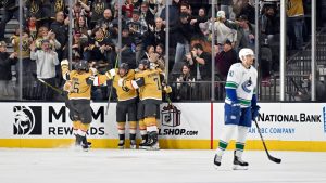 The Vegas Golden Knights celebrate centre William Karlsson's goal against the Vancouver Canucks during the third period of an NHL hockey game Thursday, Dec. 19, 2024, in Las Vegas. (David Becker/AP)