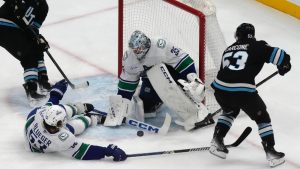 Vancouver Canucks goaltender Thatcher Demko (35) makes a save against Utah Hockey Club left wing Michael Carcone (53) during the first period of an NHL hockey game Wednesday, Dec. 18, 2024, in Salt Lake City. (Rick Bowmer/AP)