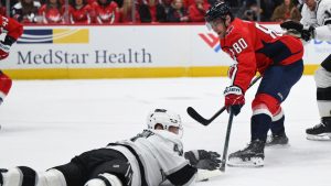 Washington Capitals left wing Pierre-Luc Dubois (80) has his shot defended by Los Angeles Kings defenseman Mikey Anderson during the first period of an NHL hockey game, Sunday, Dec. 22, 2024, in Washington. (Terrance Williams/AP)