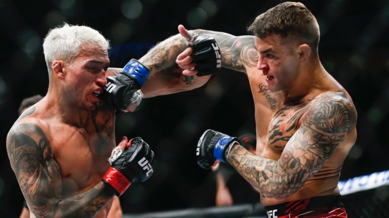 Charles Oliveira, left, fights Dustin Poirier during a lightweight mixed martial arts title bout at UFC 269 in 2021. (Chase Stevens/AP)