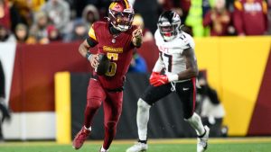 Washington Commanders quarterback Jayden Daniels (5) carries on a keeper during the second half of an NFL football game against the Atlanta Falcons, Sunday, Dec. 29, 2024, in Landover, Md. (AP Photo/Nick Wass)