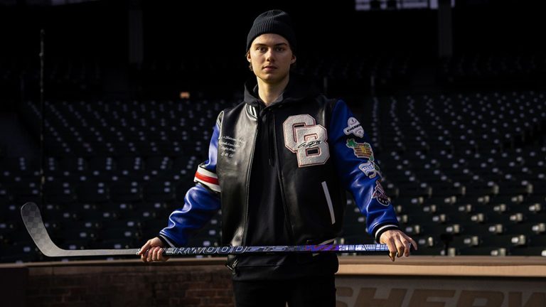 Chicago Blackhawks star Connor Bedard with the special edition stick and varsity jacket from Sherwood's Bedard Chi-town Collaboration Collection. (Photo courtesy Sherwood Hockey)