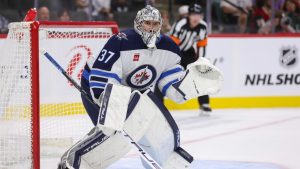 Winnipeg Jets goaltender Connor Hellebuyck (37) focuses on the play during the first period of a preseason NHL hockey game against the Minnesota Wild, Friday, Sept. 27, 2024, in St. Paul, Minn. (Bailey
Hillesheim/AP)