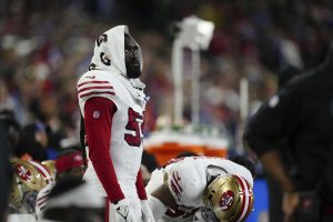 De'Vondre Campbell (59) looks on with a Gatorade towel over his head during an NFL football game. (Ben VanHouten/AP)