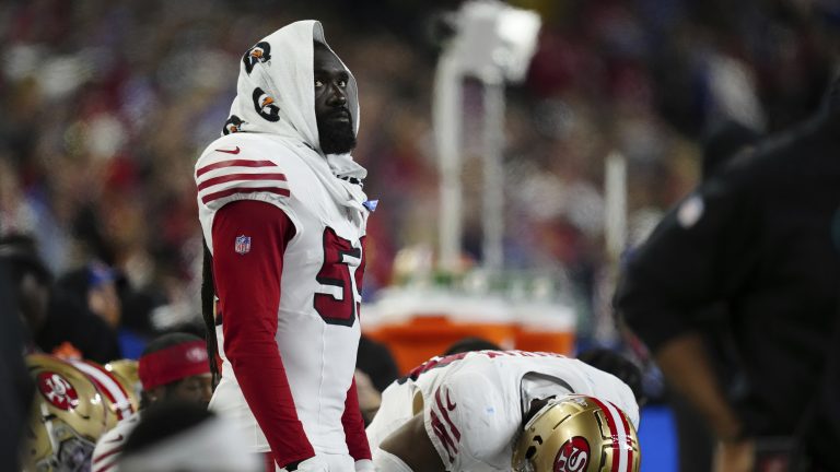 De'Vondre Campbell (59) looks on with a Gatorade towel over his head during an NFL football game. (Ben VanHouten/AP)