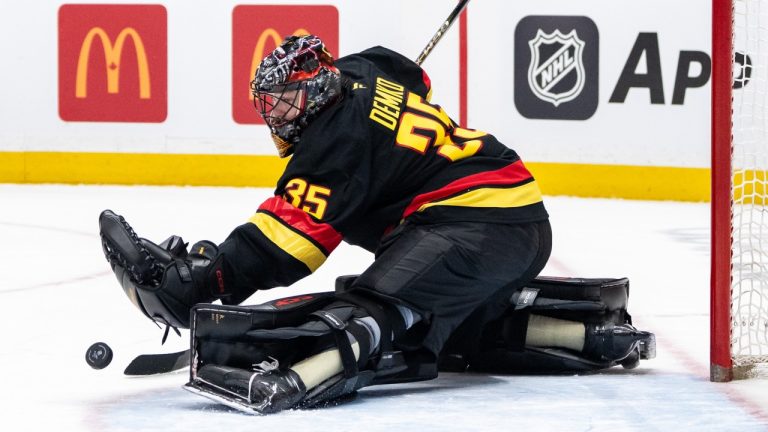 Vancouver Canucks goaltender Thatcher Demko (35) stops the puck against the San Jose Sharks during first period NHL hockey action in Vancouver, B.C., Monday, Dec. 23, 2024. (Ethan Cairns/CP)