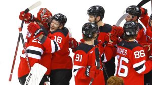 New Jersey Devils goaltender Jacob Markstrom (25) receives as hug from teammate Ondrej Palat (18) after defeating the New York Rangers, Monday, Dec. 23, 2024, in Newark, N.J. (Noah K. Murray/AP)