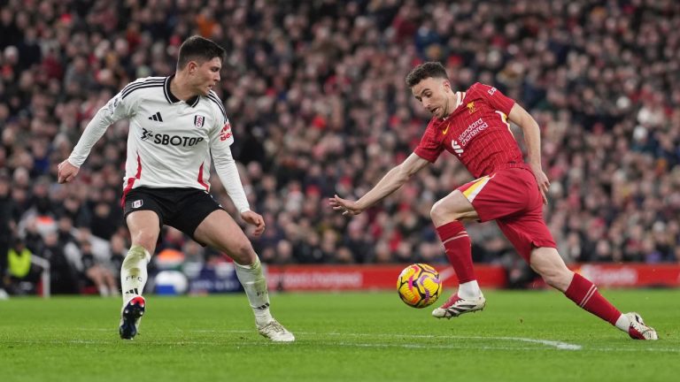 Liverpool's Diogo Jota, right, scores his side's second goal during the English Premier League match between Liverpool and Fulham, at Anfield stadium in Liverpool, England, Saturday, Dec. 14, 2024. (AP/Jon Super)