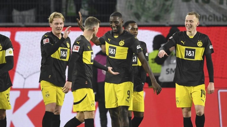 Dortmund's Julian Brandt, centre applauds Dortmund's Serhou Guirassy after his goal during the Bundesliga soccer match between VfL Wolfsburg and Borussia Dortmund, in Wolfsburg, Germany, Sunday Dec. 22, 2024. (Swen Pförtner/dpa/AP)