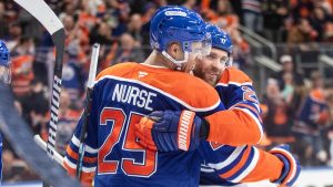 Edmonton Oilers' Darnell Nurse (25) and Leon Draisaitl (29) celebrate a goal against the Vegas Golden Knights during second period NHL action in Edmonton, Saturday, Dec. 14, 2024. (Jason Franson/CP)