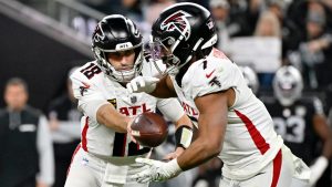 Atlanta Falcons quarterback Kirk Cousins (18) hands off to running back Bijan Robinson during the first half of an NFL football game against the Las Vegas Raiders, Monday, Dec. 16, 2024, in Las Vegas. (David Becker/AP)