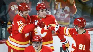 Calgary Flames' Jonathan Huberdeau (10) celebrates his goal with teammates during first period NHL hockey action against the Tampa Bay Lightning in Calgary, Alta., Thursday, Dec. 12, 2024. (Jeff McIntosh/CP)