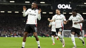 Fulham's Alex Iwobi, left, celebrates after scoring the opening goal during the English Premier League match between Fulham and Wolverhampton Wanderers. (Zac Goodwin/PA via AP)