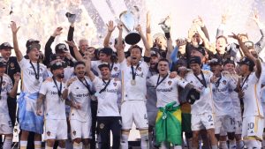 The Los Angeles Galaxy lift the winners' trophy after defeating the New York Red Bulls in the MLS Cup championship. (Etienne Laurent/AP)