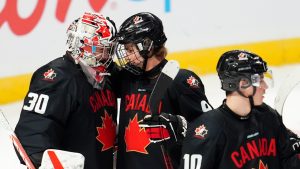 Canada's Gavin McKenna (9) and Canada's Carter George (30) celebrate the team's win over Czechia following third period World Junior Championship hockey pre-tournament action in Ottawa, Monday, Dec. 23, 2024. (Sean Kilpatrick/CP)