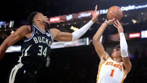 Atlanta Hawks forward Jalen Johnson (1) shoots against Milwaukee Bucks forward Giannis Antetokounmpo (34) during the first half of a semifinal game in the NBA Cup basketball tournament. (Ian Maule/AP)