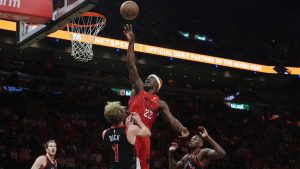 Miami Heat forward Jimmy Butler (22) drives to the basket as Toronto Raptors guard Gradey Dick (1) defends during the first half of an NBA basketball game, Thursday, Dec. 12, 2024, in Miami. (Marta Lavandier/AP)